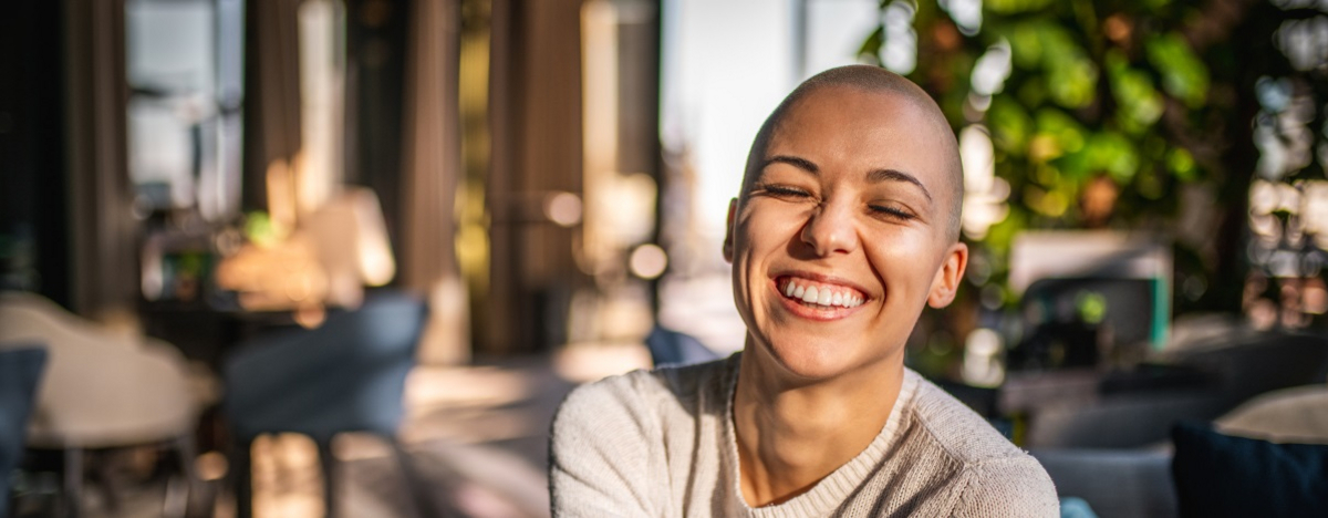 Portr&auml;t eines l&auml;chelnden M&auml;dchens mit kurzen Haaren und geschlossenen Augen