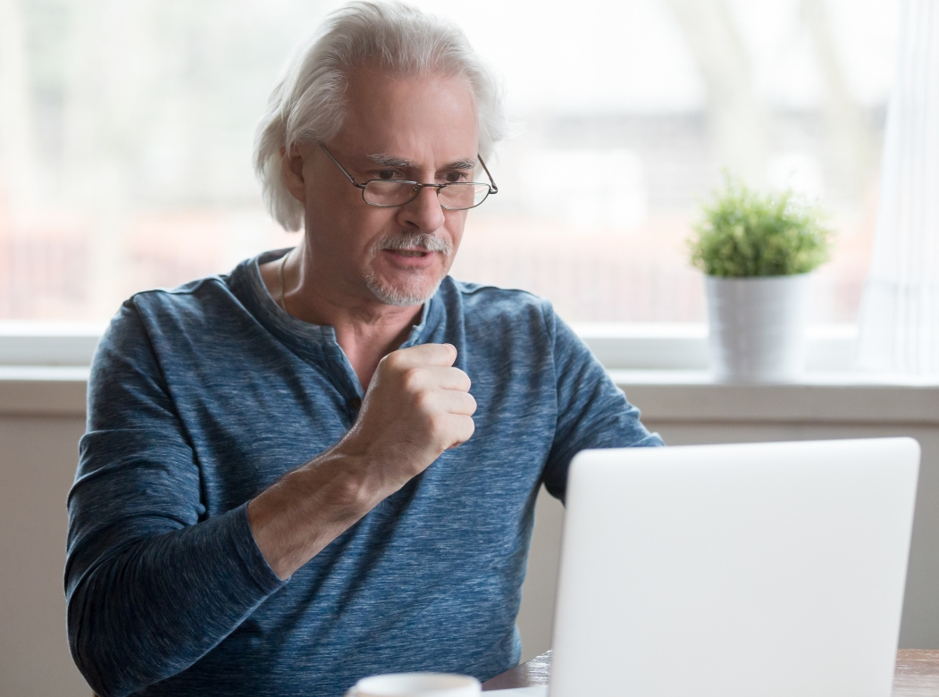 Mann im mittleren Alter am Notebook sitzend