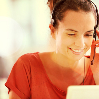 Frau mit Headset am Computer