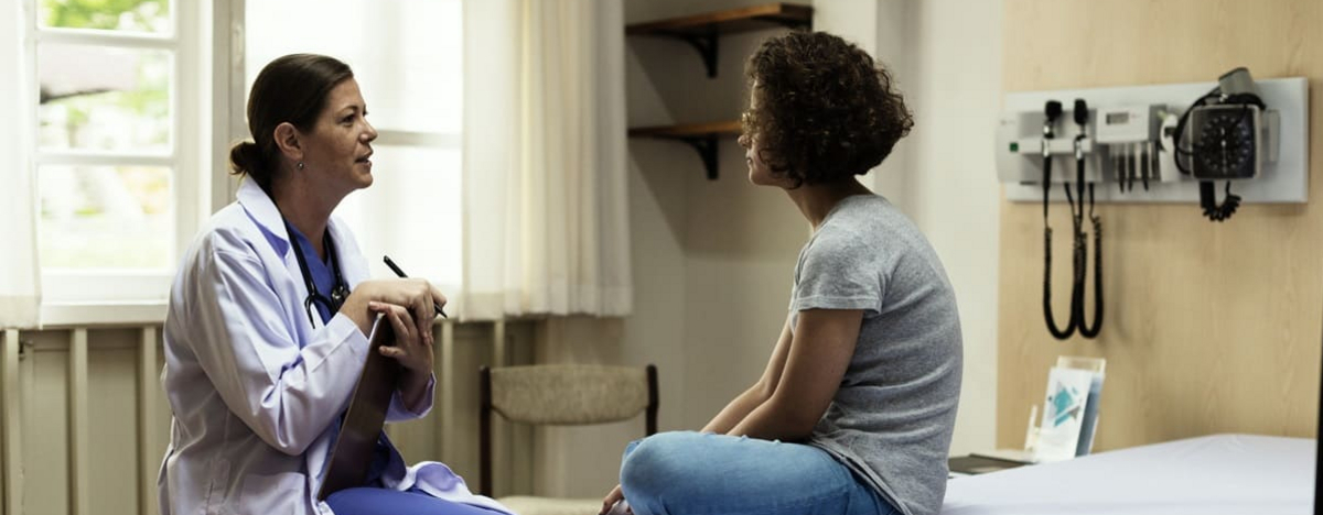 Eine &Auml;rztin spricht mit einer Patientin im Krankenhaus wegen ihrer Autoimmunerkrankung.